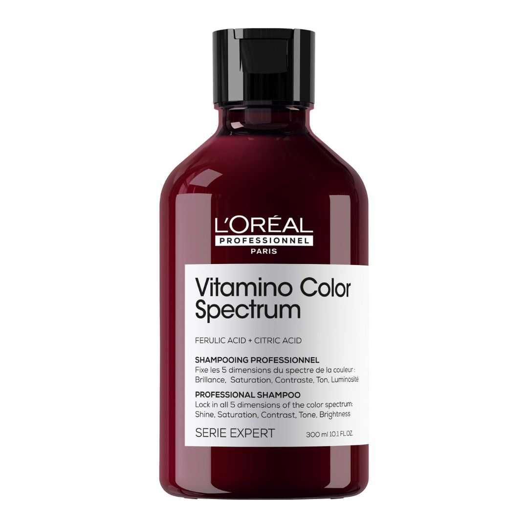A bottle of L'Oreal Professionnel Vitamino Color Spectrum Shampoo with dark liquid inside and a label that includes the product name and that it is a professional series shampoo.