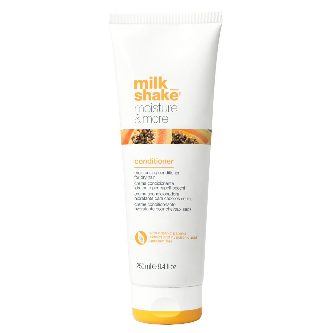 A tube of milk_shake Moisture & More Conditioner in white packaging with orange accents and branding details.