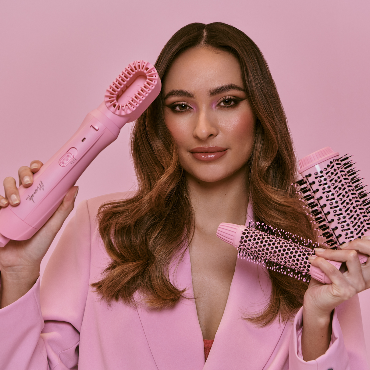 Model using the Mermade Hair Pink Interchangeable Blow Dry Brush