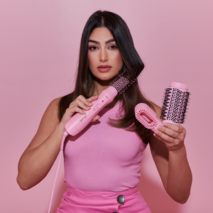 Model using the Mermade Hair Pink Interchangeable Blow Dry Brush