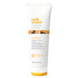 A tube of milk_shake Moisture & More Conditioner in white packaging with orange accents and branding details.