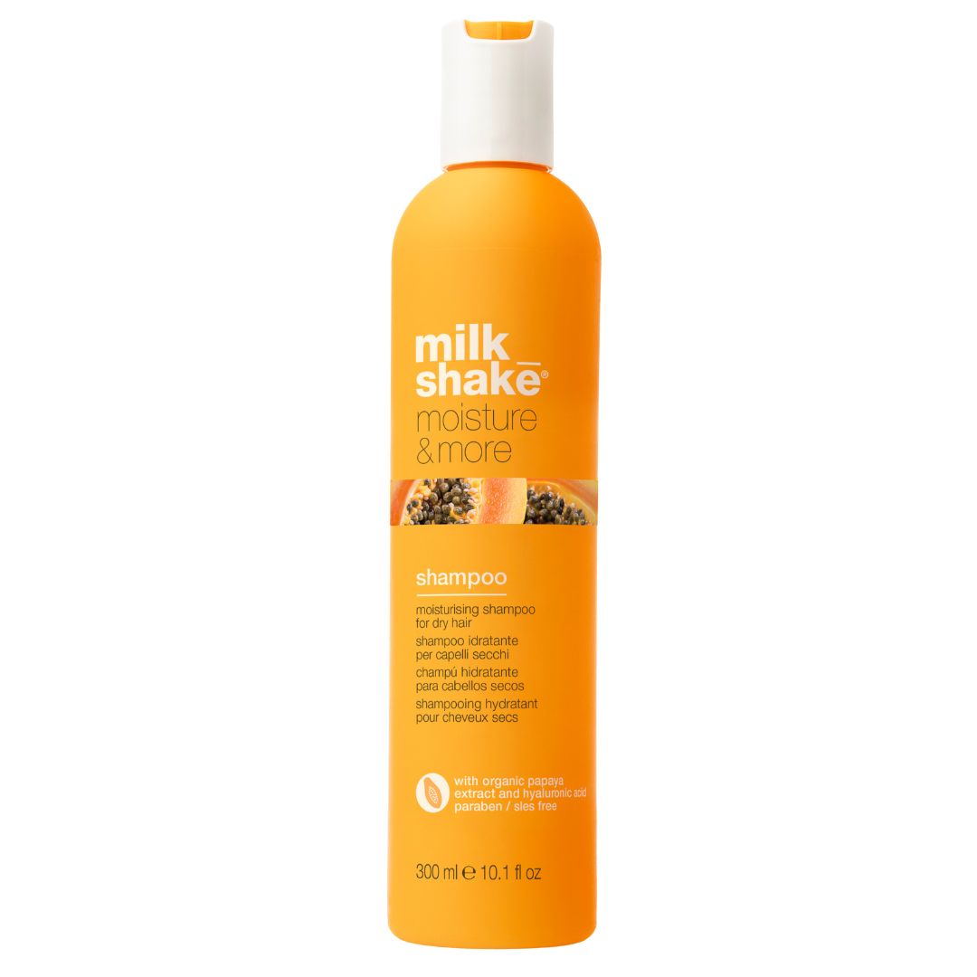 A bottle of milk_shake Moisture & More Shampoo with a capacity of 300ml. The bottle is predominantly orange with product details and branding printed on it.